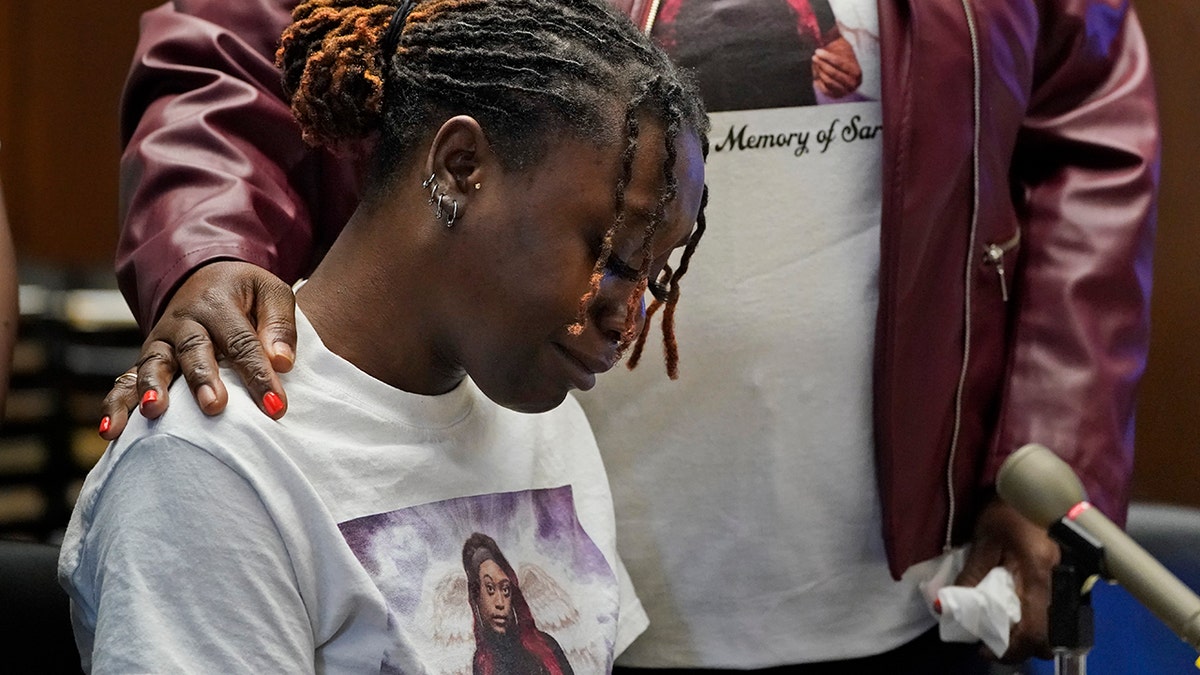 Aliyah, left, and Laverne Butler, sister and mother of Sarah Butler, wear shirts with Sarah Butler's picture as they give victim impact statements during the sentencing for Khalil Wheeler-Weaver in Newark, N.J., Wednesday, Oct. 6, 2021. Wheeler-Weaver, a New Jersey man who used dating apps to lure three women, including Robin West, to their deaths and attempted to kill a fourth woman five years ago, was sentenced to 160 years in prison on Wednesday, as he defiantly proclaimed his innocence. (AP Photo/Seth Wenig, Pool)