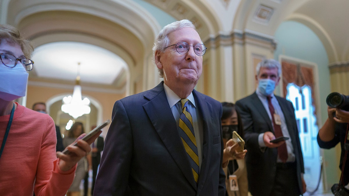 Senate Minority Leader Mitch McConnell, R-Ky., is surrounded by journalists as he walks to the Senate Chamber for a vote as Democrats look for a way to lift the debt limit without Republican votes, at the Capitol in Washington, Wednesday, Oct. 6, 2021. (AP Photo/J. Scott Applewhite)