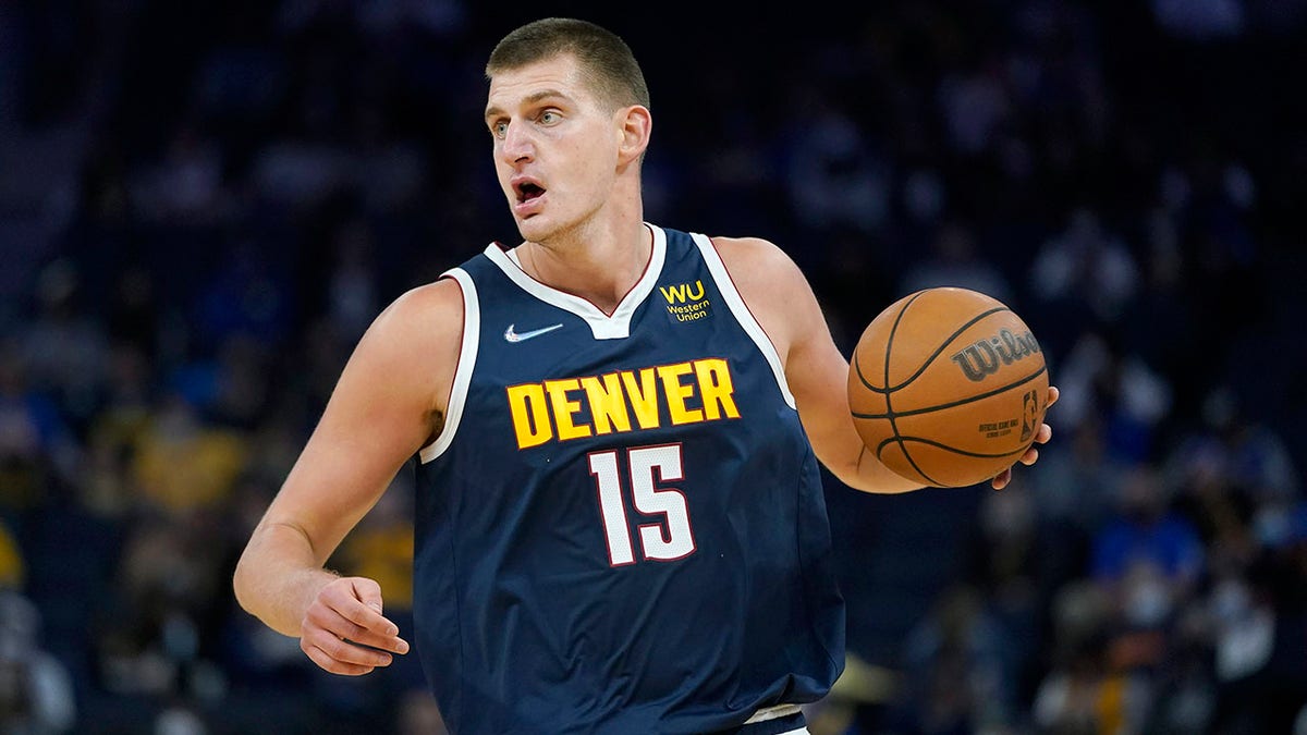 Denver Nuggets center Nikola Jokic dribbles aduring the first half of the team's preseason NBA basketball game against the Golden State Warriors in San Francisco, Wednesday, Oct. 6, 2021. (AP Photo/Jeff Chiu)