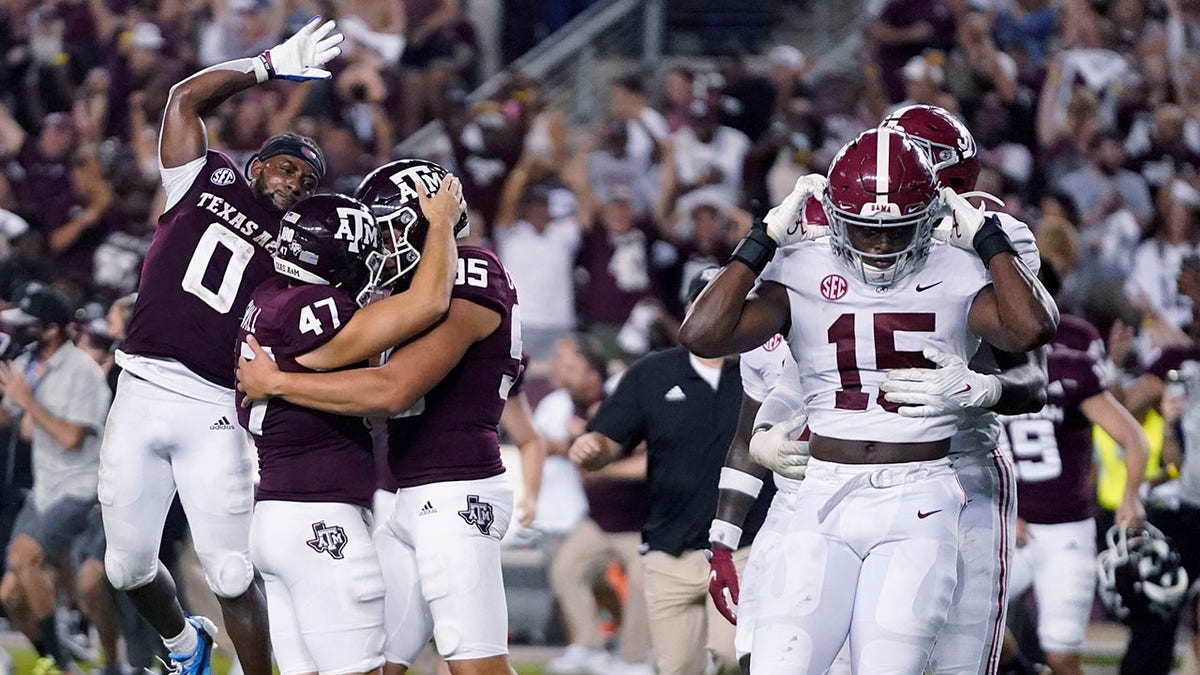 Texas A&amp;amp;M's Seth Small (47) celebrates with Nik Constantinou (95) and Ainias Smith (0) after his game-winning field goal, as Alabama linebackers Dallas Turner (15) and Will Anderson Jr. leave the field after an NCAA college football game Saturday, Oct. 9, 2021, in College Station, Texas. (AP Photo/Sam Craft)