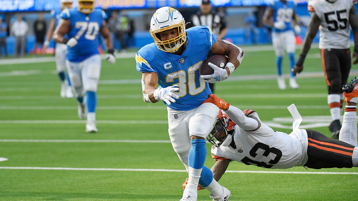 Los Angeles Chargers running back Austin Ekeler scores a touchdown past Cleveland Browns free safety John Johnson (43) during the second half Sunday.