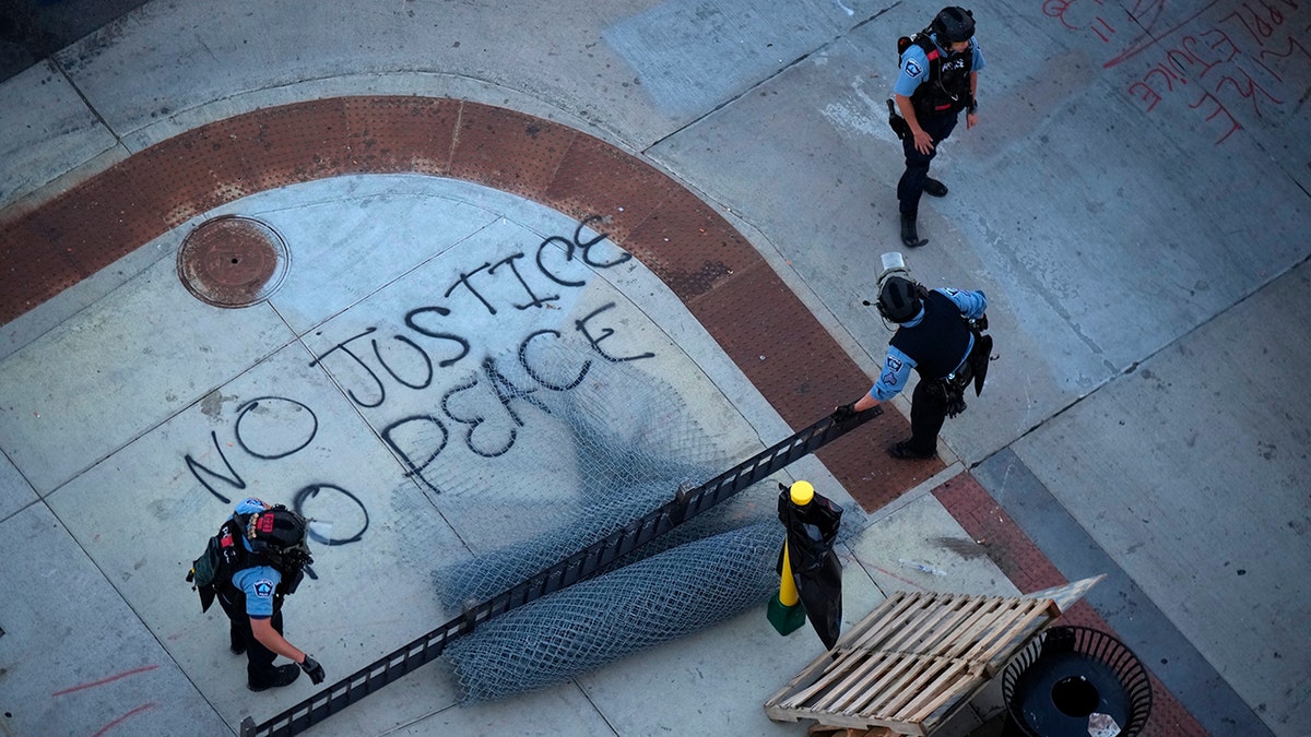 No Justice No Peace slogan painted on the sidewalk