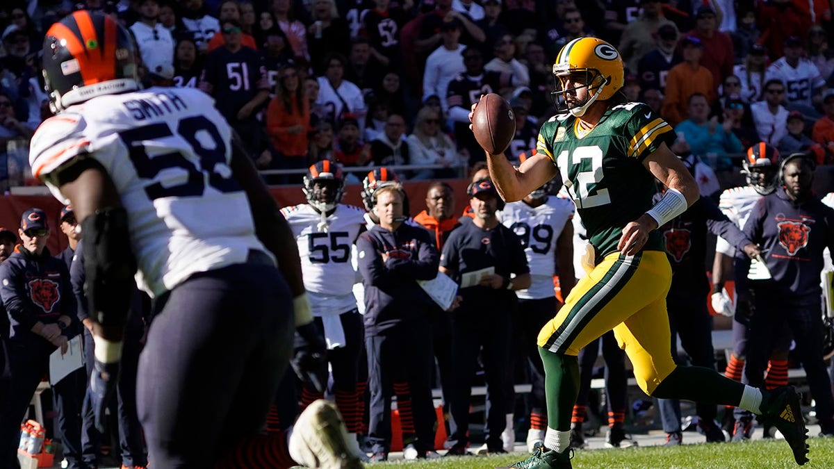Green Bay Packers quarterback Aaron Rodgers pulls the ball down and runs for a touchdown during the second half of an NFL football game against the Chicago Bears Sunday, Oct. 17, 2021, in Chicago.