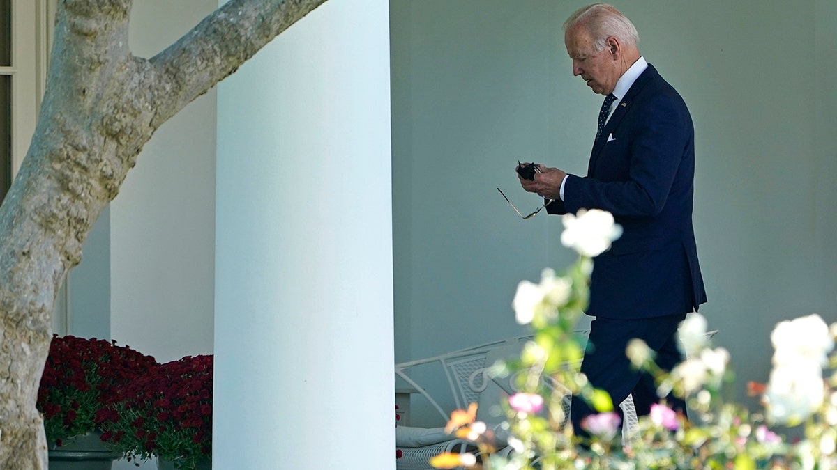 Oct. 18, 2021: President Joe Biden puts his mask back on as he walks back to the Oval Office. (Associated Press)