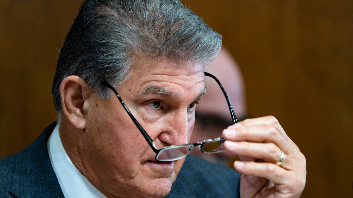 Joe Manchin taking off his glasses