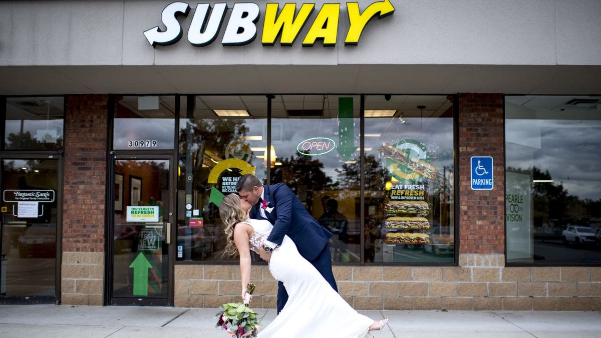 Julie Bushart and Zack Williams celebrated their first anniversary at Subway to commemorate their first meeting. Three years later got wedding photos taken in front of the restaurant where their love story began.