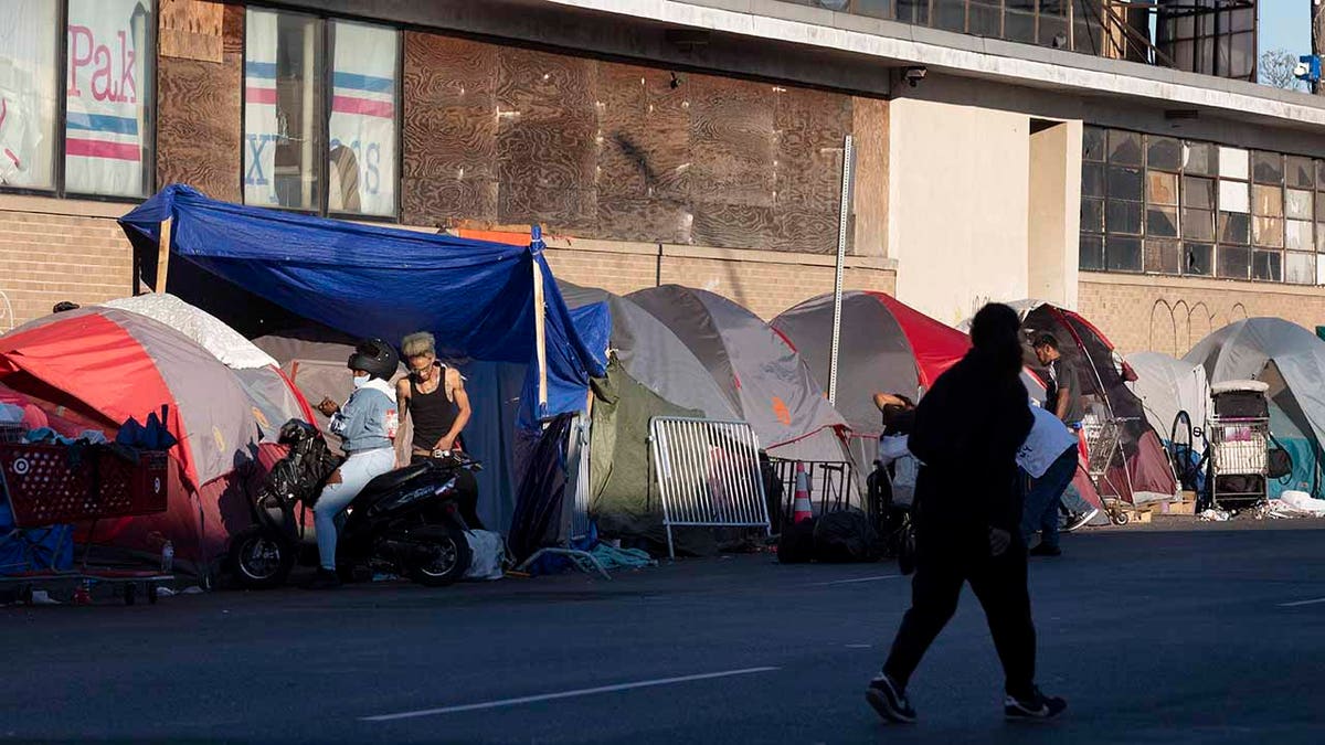 The tents of a homeless camp line the sidewalk in area commonly known as Mass and Cass, Oct. 23, 2021, in Boston.