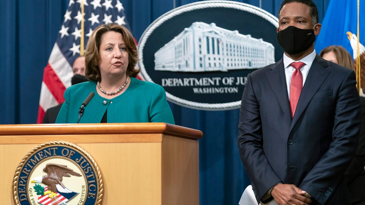 Deputy Attorney General Lisa Monaco, with Assistant Attorney General Kenneth Polite Jr. of the Justice Department's Criminal Division, speaks during a news at the Department of Justice in Washington, Tuesday, Oct. 26, 2021. Law enforcement officials in the U.S. and Europe have arrested 150 people and seized more than $31 million in an international drug trafficking investigation stemming from sales on the darknet. (AP Photo/Manuel Balce Ceneta)