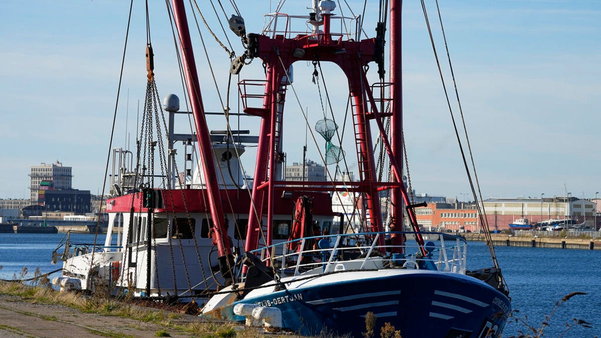 The British trawler kept by French authorities docks at the port in Le Havre, western France, Thursday, Oct. 28, 2021. French authorities fined two British fishing vessels and kept one in port overnight Thursday Oct.28, 2021 amid a worsening dispute over fishing licenses that has stoked tensions following the U.K.'s departure from the European Union. (AP Photo/Michel Euler)