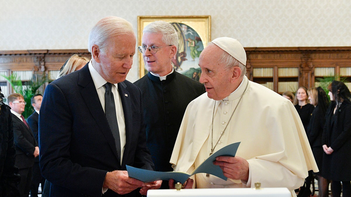 President Biden exchanges gifts with Pope Francis as they meet at the Vatican on Oct. 29, 2021.