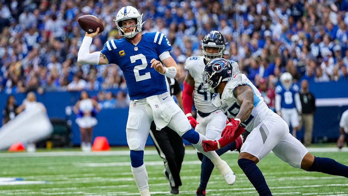 Indianapolis Colts quarterback Carson Wentz (2) throws under pressure from Tennessee Titans defensive end Jeffery Simmons (98) in the first half Sunday, Oct. 31, 2021. 