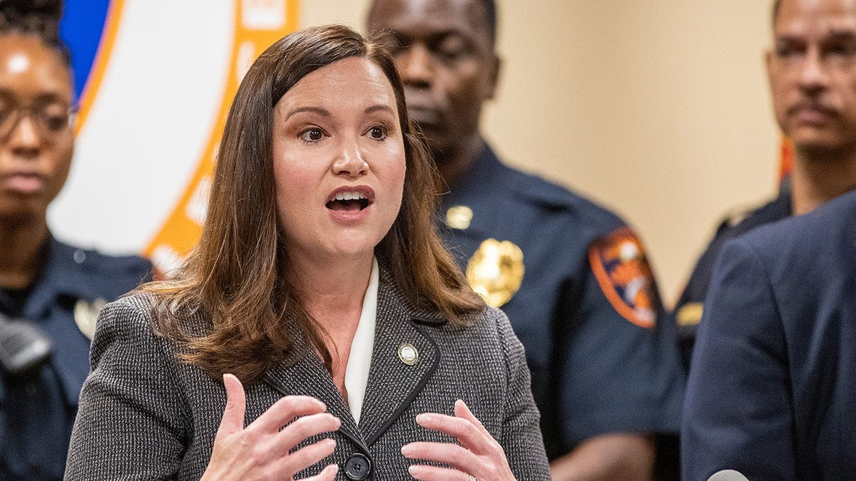 Florida Attorney General Ashley Moody speaks in front of police officers in uniform