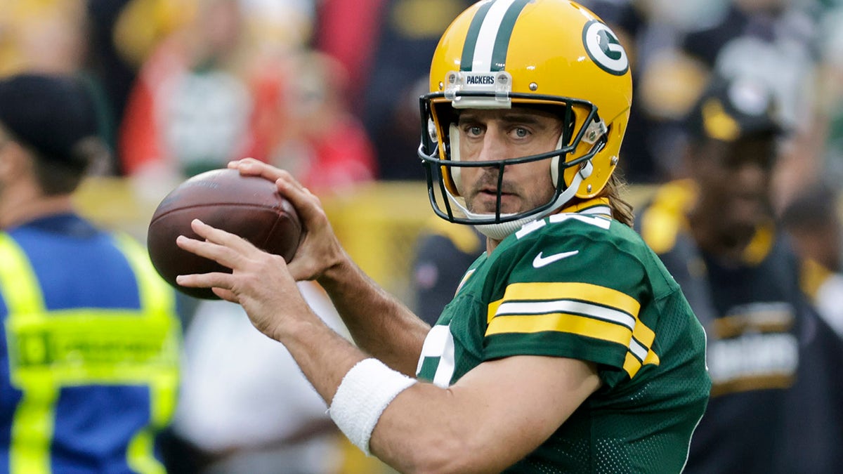 Green Bay Packers quarterback Aaron Rodgers warms up before an NFL football game against the Pittsburgh Steelers, Oct. 3, 2021, in Green Bay, Wisconsin.