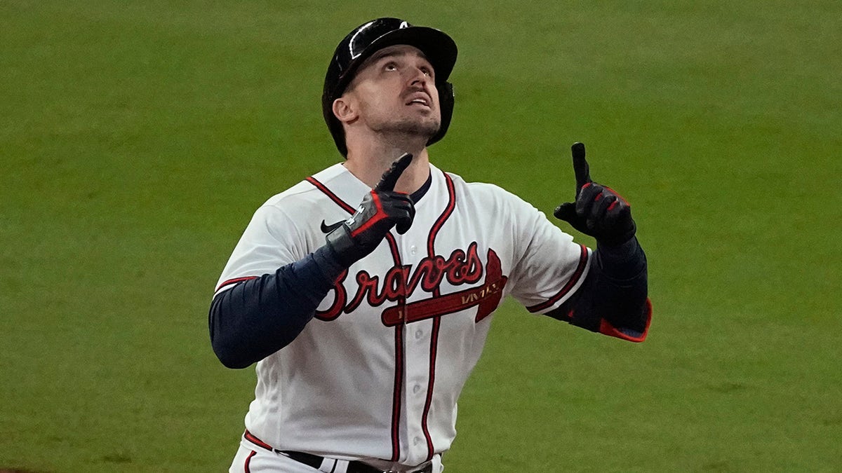 The Atlanta Braves' Adam Duvall celebrates his grand slam home run during the first inning in Game 5 of baseball's World Series between the Houston Astros and the Braves Sunday, Oct. 31, 2021, in Atlanta.