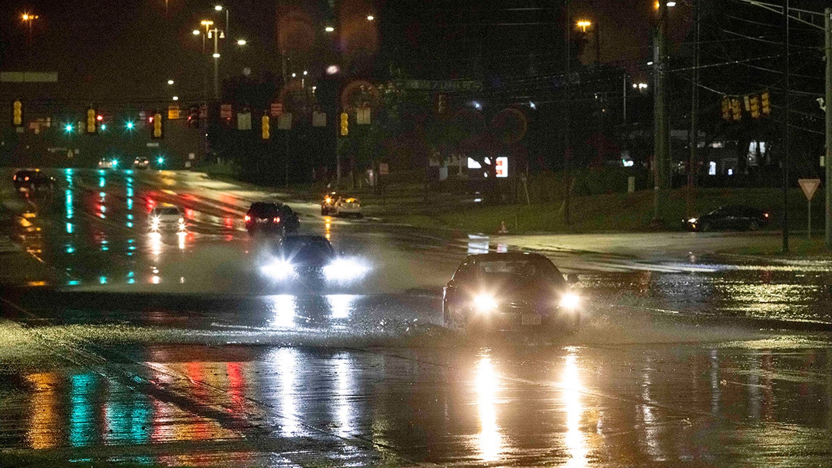 Cars travel through floodwaters on the Montgomery Highway Wednesday near the Riverchase Galleria complex in Birmingham, Ala.
