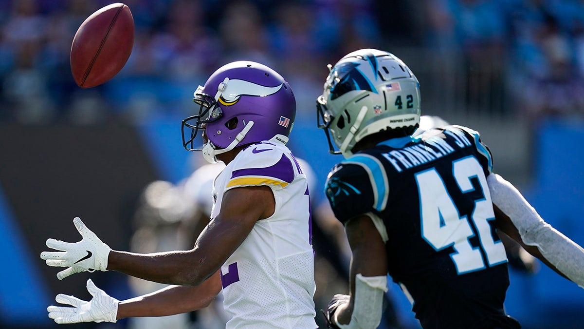 Minnesota Vikings long snapper Andrew DePaola (42) bobbles a punt return against Carolina Panthers safety Sam Franklin (42) during the second half of an NFL football game, Sunday, Oct. 17, 2021, in Charlotte, N.C.