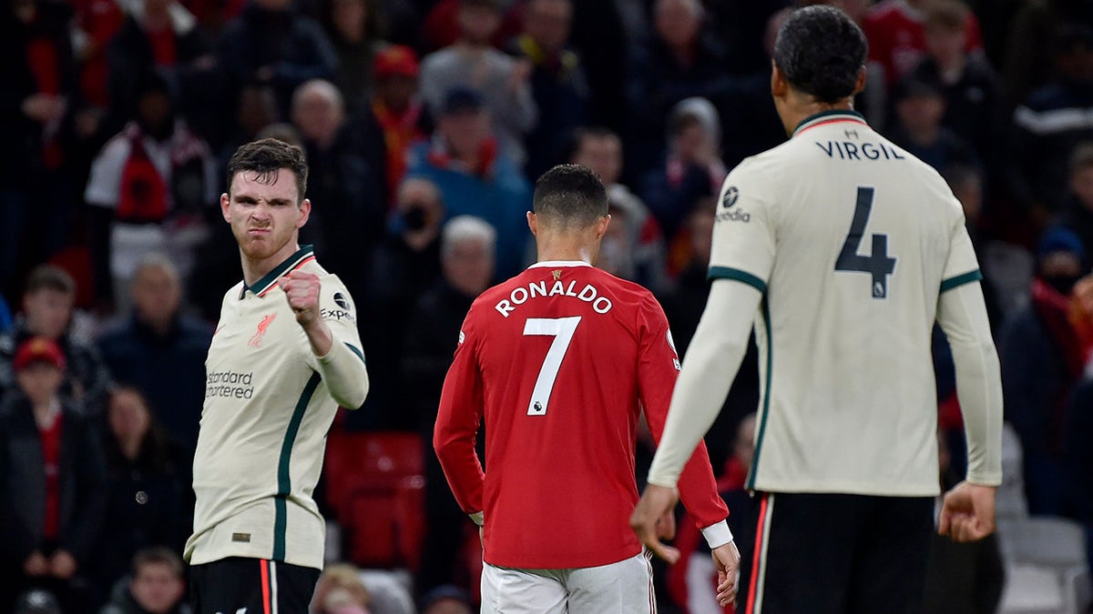 Liverpool's Andrew Robertson, left, gestures next to Manchester United's Cristiano Ronaldo at the end of the English Premier League soccer match between Manchester United and Liverpool at Old Trafford in Manchester, England, Sunday, Oct. 24, 2021. Liverpool won 5-0.