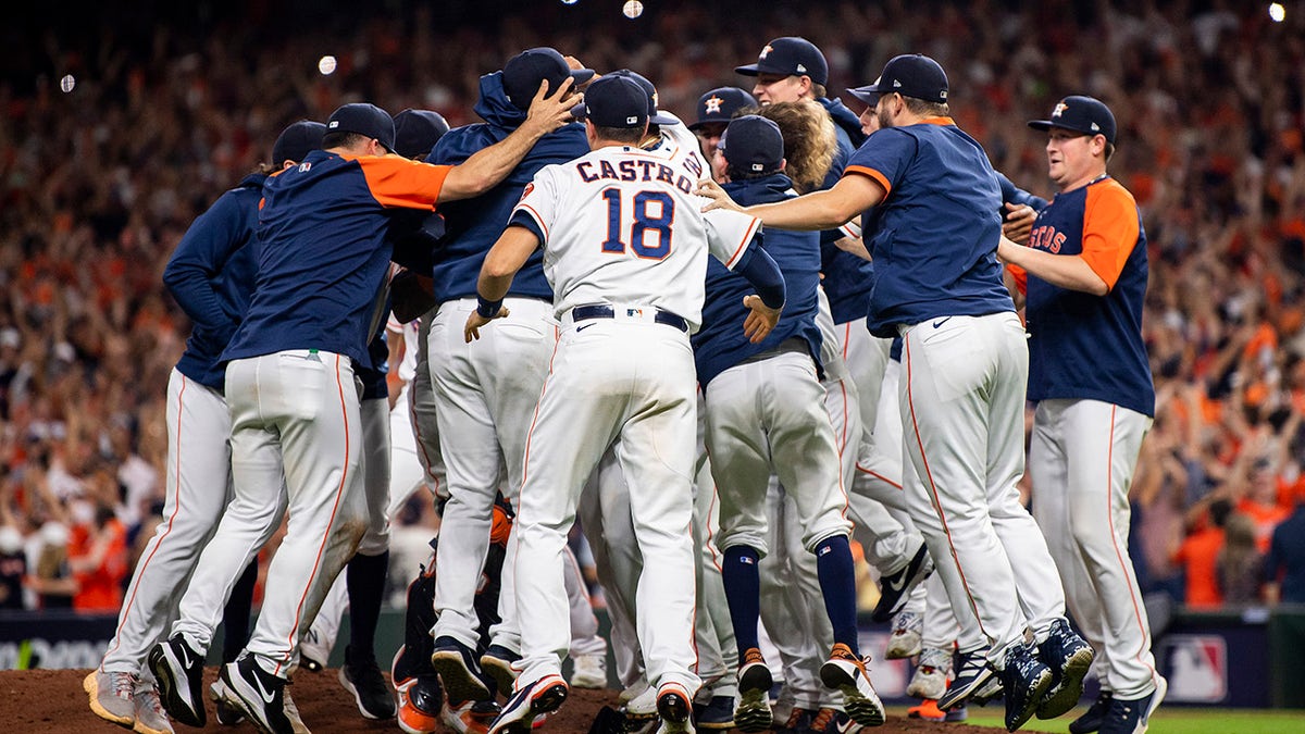 Members of the Houston Astros celebrate after defeating the Boston Red Sox in game six to clinch the 2021 American League Championship Series at Minute Maid Park on Oct. 22, 2021 in Houston, Texas.