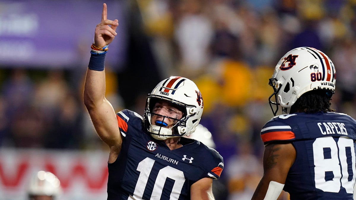Auburn quarterback Bo Nix (10) celebrates after scoring a touchdown in the second half of an NCAA college football game against Auburn in Baton Rouge, La., Saturday, Oct. 2, 2021. Auburn won 24-19.