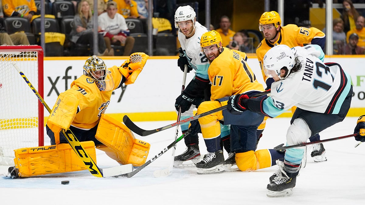 Seattle Kraken left wing Brandon Tanev (13) scores a goal against Nashville Predators goaltender Juuse Saros (74) in the first period of an NHL hockey game Thursday, Oct. 14, 2021, in Nashville, Tenn.