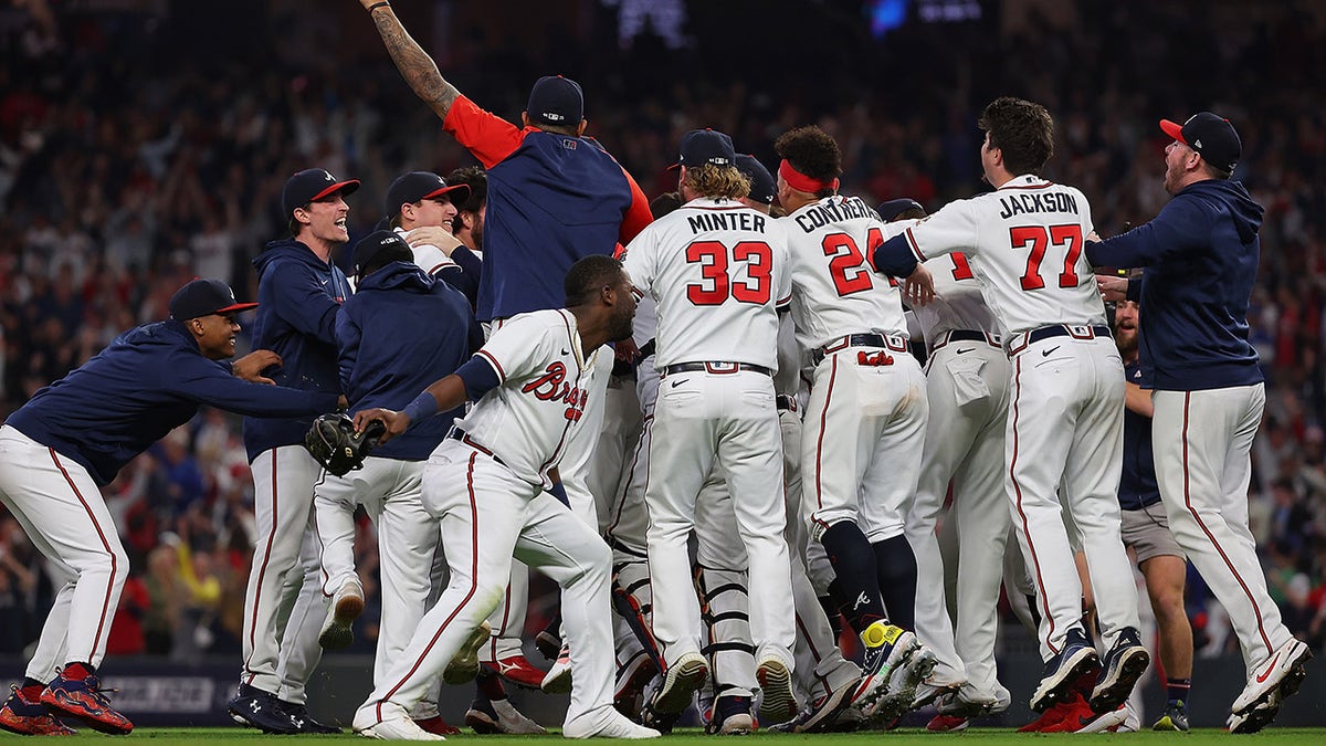 Members of the Atlanta Braves celebrate after defeating the Los Angeles Dodgers in Game Six of the National League Championship Series at Truist Park on October 23, 2021 in Atlanta, Georgia. The Braves defeated the Dodgers 4-2 to advance to the 2021 World Series.