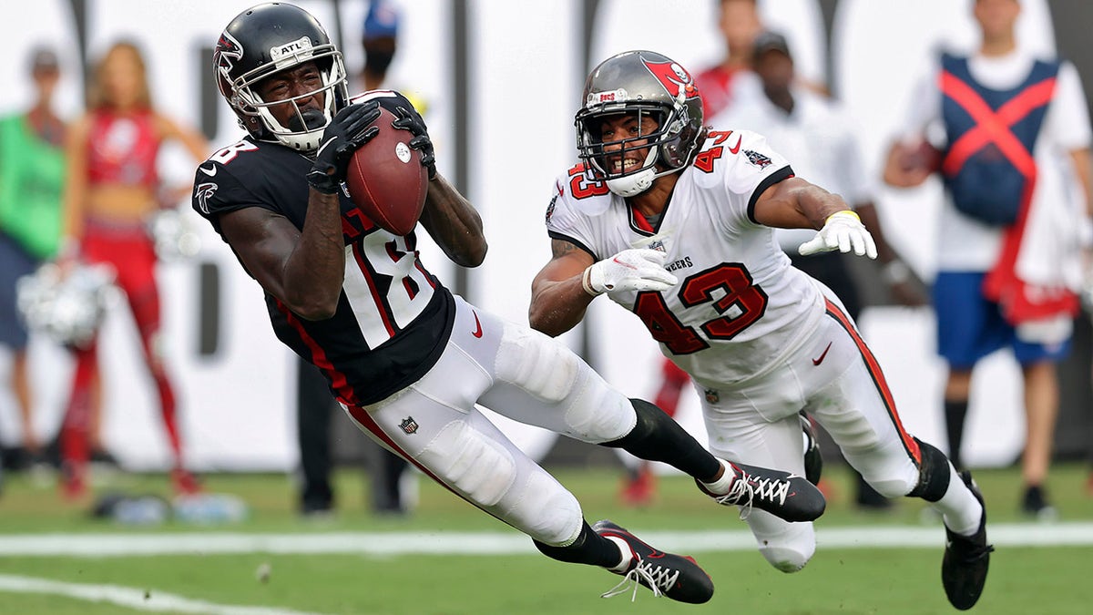 FILE - Atlanta Falcons wide receiver Calvin Ridley (18) makes a diving touchdown reception in front of Tampa Bay Buccaneers defensive back Ross Cockrell (43) during the second half of an NFL football game in Tampa, Fla., in this Sunday, Sept. 19, 2021, file photo.