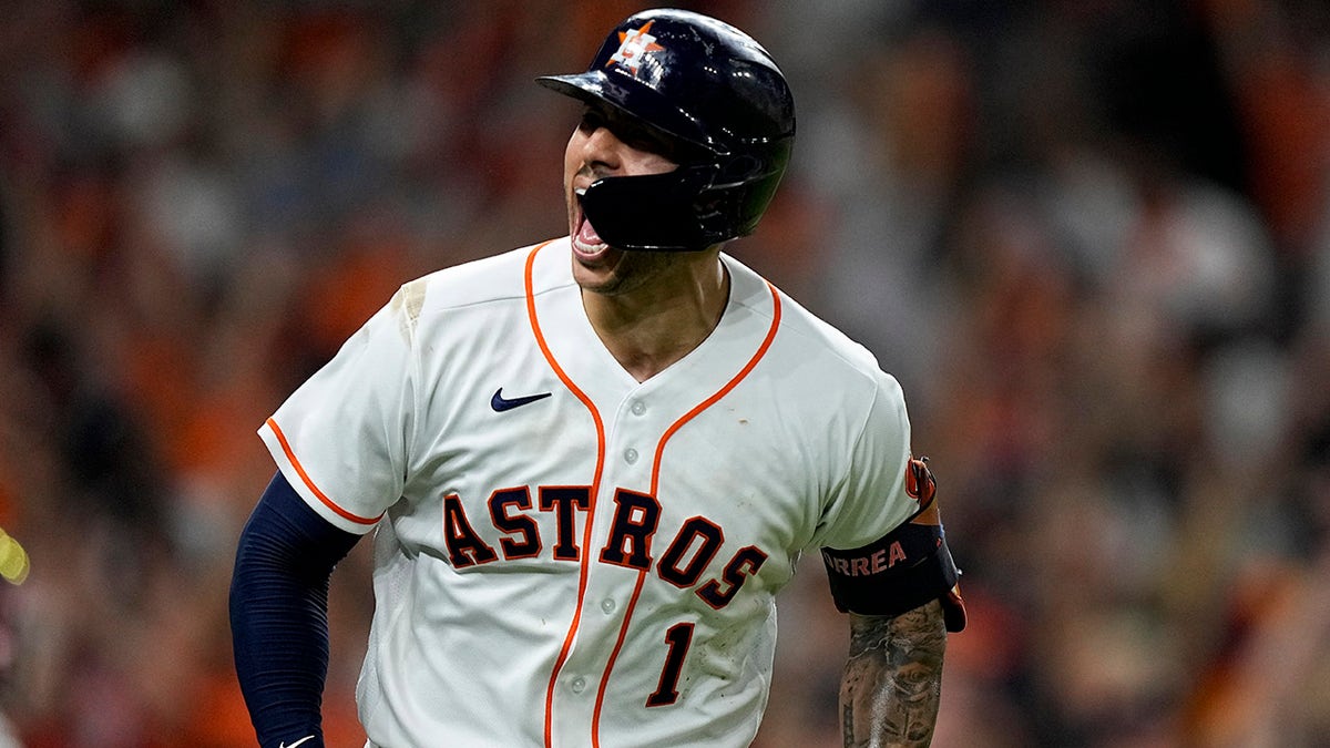 Houston Astros' Carlos Correa celebrates a home run against the Boston Red Sox during the seventh inning in Game 1 of baseball's American League Championship Series Friday, Oct. 15, 2021, in Houston.