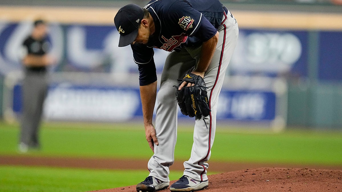 Atlanta Braves starting pitcher Charlie Morton rubs his leg before leaving the game during the third inning of Game 1 in baseball's World Series between the Houston Astros and the Atlanta Braves Tuesday, Oct. 26, 2021, in Houston.
