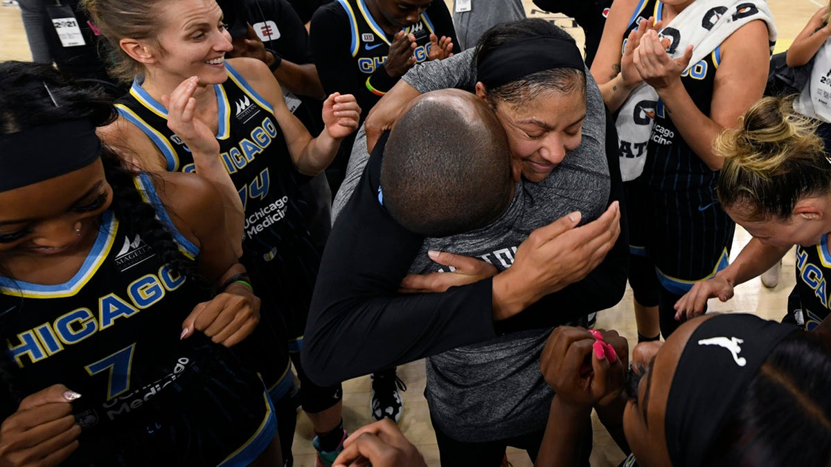 Chicago Sky's Candice Parker, coach James Wade and teammates celebrate after defeating the Connecticut Sun 79-69 in Game 4 of a WNBA basketball semifinal series Wednesday, Oct. 6, 2021, in Chicago.