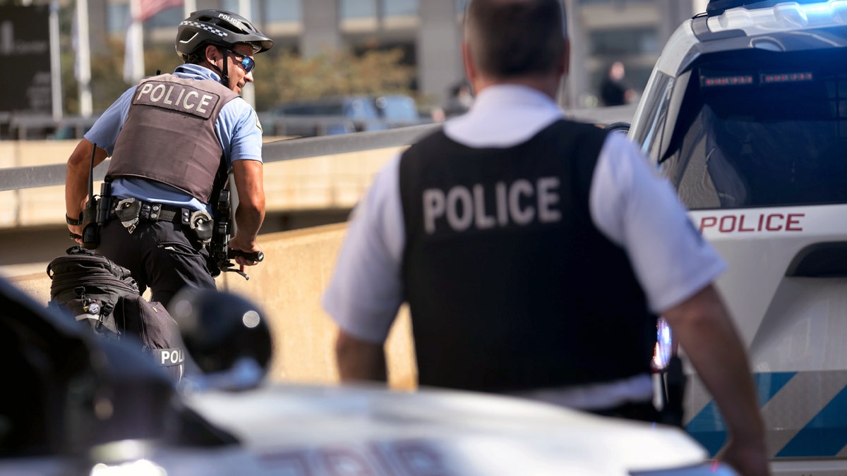 Chicago police officers work at the scene near where two officers were shot at 63rd Street and Bell Avenue in Chicago on Aug. 7, 2021.