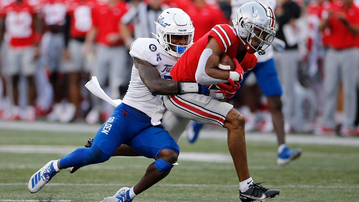 Tulsa defensive back TieNeal Martin, left, tackles Ohio State receiver Chris Olave during the second half of an NCAA college football game Saturday, Sept. 18, 2021, in Columbus, Ohio. 