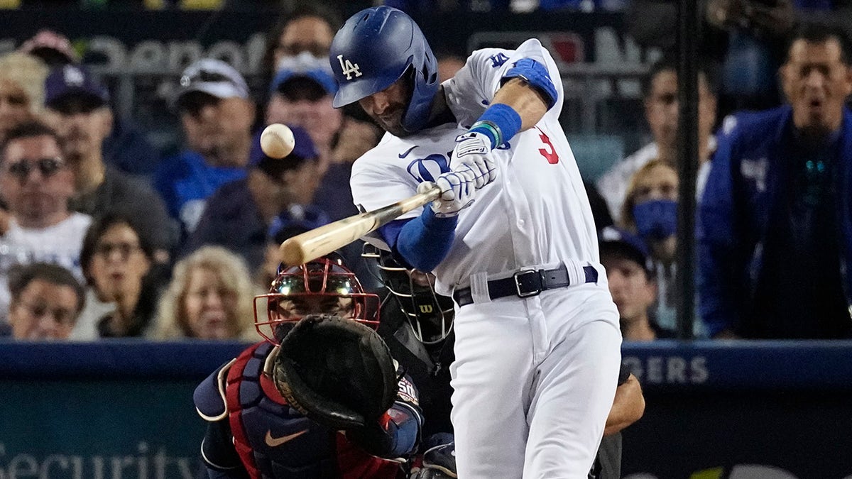Los Angeles Dodgers' Chris Taylor hits an RBI single in the third inning against the Atlanta Braves in Game 5 of baseball's National League Championship Series Thursday, Oct. 21, 2021, in Los Angeles.