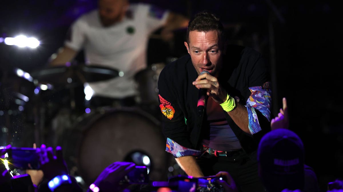 Chris Martin of Coldplay performs live on stage at O2 Arena Shepherd's Bush Empire on October 12, 2021 in London, England. The same night he serenaded girlfriend Dakota Johnson with the song ‘Universe.’