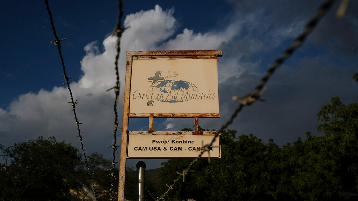 A custom sign stands outside Christian Aid Ministries in Titanyen, Haiti, Thursday, Oct. 21, 2021. ?