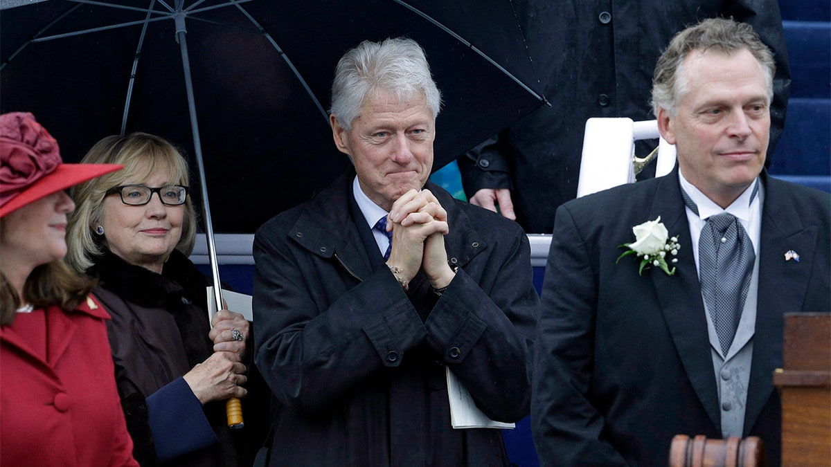 FILE – Former President Bill Clinton, center, and former Secretary of State Hillary Rodham Clinton look on as Virginia Gov. Terry McAuliffe prepares to deliver his inaugural address during ceremonies at the Capitol in Richmond, Va., Saturday, Jan. 11, 2014. Also pictured at left is Virginia first lady Dorothy McAuliffe.  (AP Photo/Patrick Semansky)