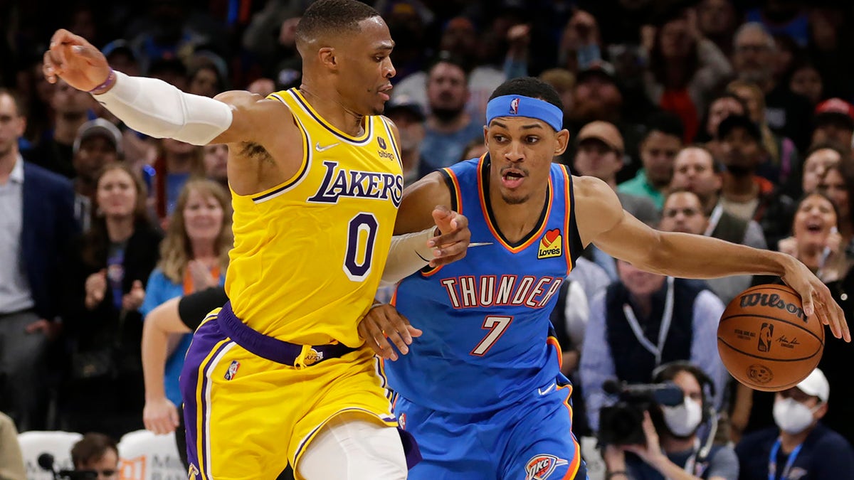 Oklahoma City Thunder forward Darius Bazley (7) goes against Los Angeles Lakers guard Russell Westbrook (0) during the second half of an NBA basketball game, Wednesday, Oct. 27, 2021, in Oklahoma City. 