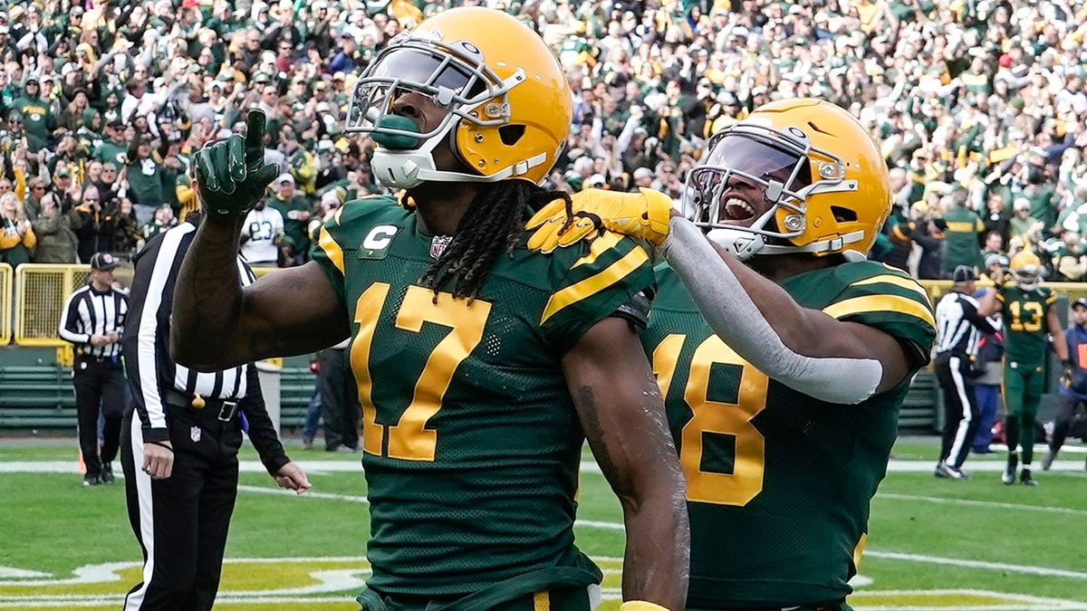 Green Bay Packers' Davante Adams celebrates his touchdown catch with Randall Cobb during the first half of a game against the Washington Football Team Sunday, Oct. 24, 2021, in Green Bay, Wisconsin.