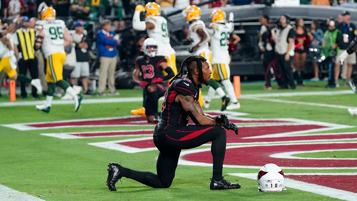 Arizona Cardinals wide receiver DeAndre Hopkins kneels after the Green Bay Packers intercepted the ball in the end zone during the second half of an NFL football game, Thursday, Oct. 28, 2021, in Glendale, Arizona. The Packers won 24-21.