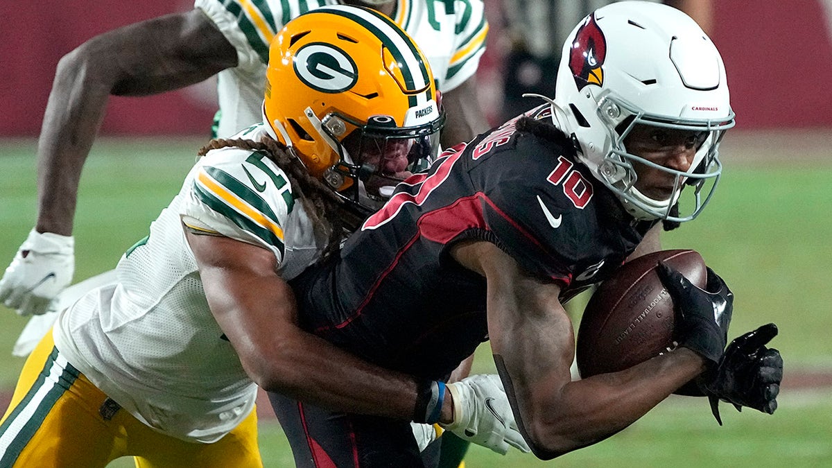 Arizona Cardinals wide receiver DeAndre Hopkins (10) is talk by Green Bay Packers cornerback Eric Stokes during the second half of an NFL football game, Thursday, Oct. 28, 2021, in Glendale, Arizona.