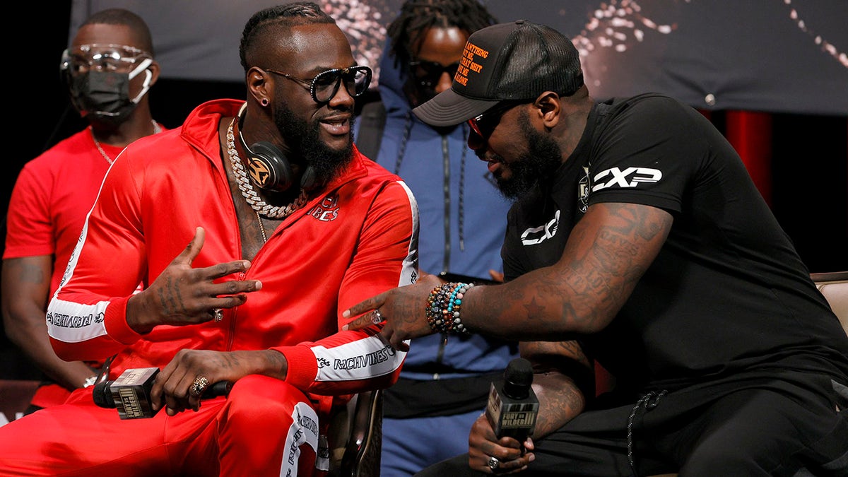 Deontay Wilder (L) talks with his head coach Malik Scott during a news conference at MGM Grand Garden Arena on Oct. 6, 2021 in Las Vegas.
