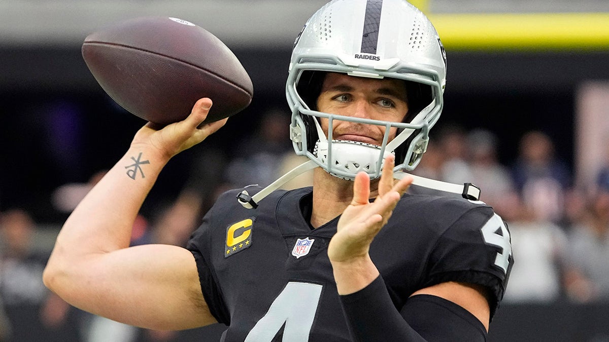 Las Vegas Raiders quarterback Derek Carr (4) warms up before an NFL football game against the Chicago Bears, Sunday, Oct. 10, 2021, in Las Vegas. 