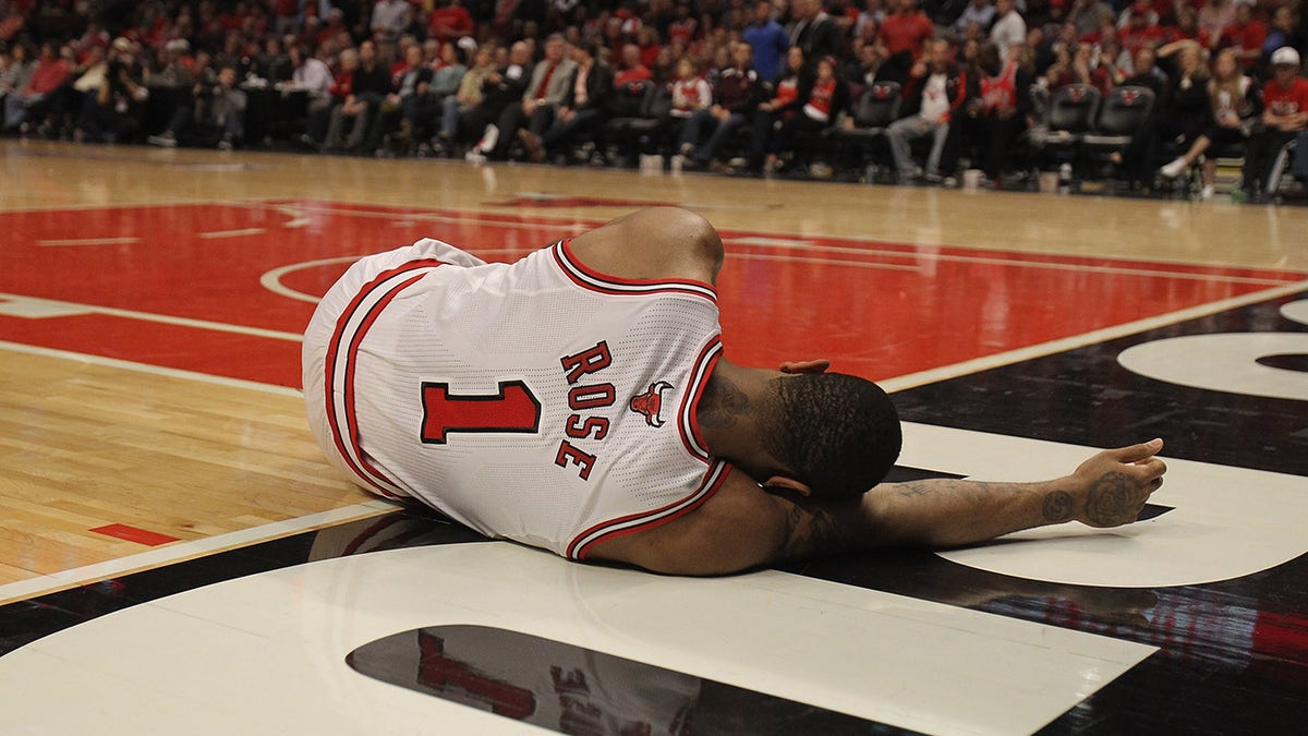 CHICAGO, IL - APRIL 28: Derrick Rose #1 of the Chicago Bulls lays on the floor aftrer suffering an injury against the Philadelphia 76ers in Game One of the Eastern Conference Quarterfinals during the 2012 NBA Playoffs at the United Center on April 28, 2012 in Chicago, Illinois. The Bulls defeated the 76ers 103-91.