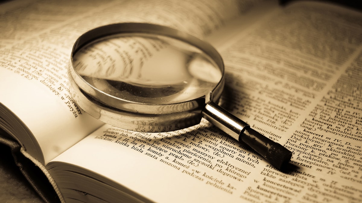 Magnifying glass and dictionary