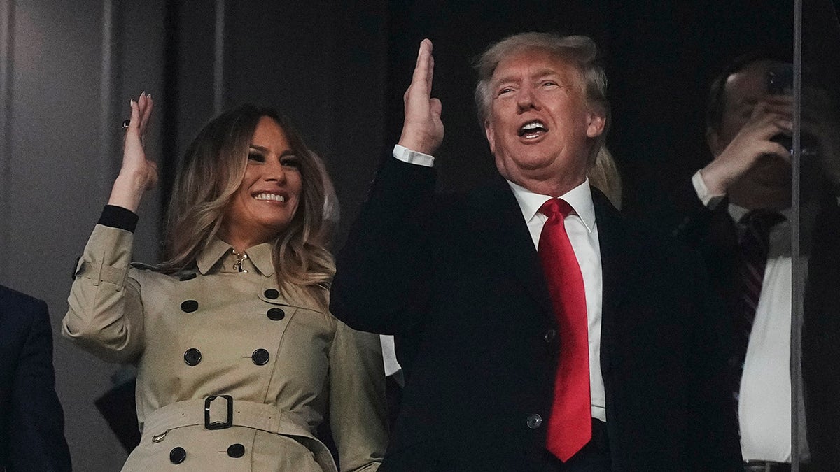 Former President Donald Trump and his wife Melania perform the tomahawk chop before for Game 4 of baseball's World Series between the Houston Astros and the Atlanta Braves Saturday, Oct. 30, 2021, in Atlanta.