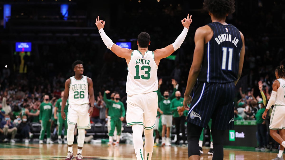Oct 4, 2021; Boston, Massachusetts, USA; Boston Celtics center Enes Kanter (13) reacts after guard Romeo Langford (9) made a three pointer during the second half against the Orlando Magic at TD Garden.