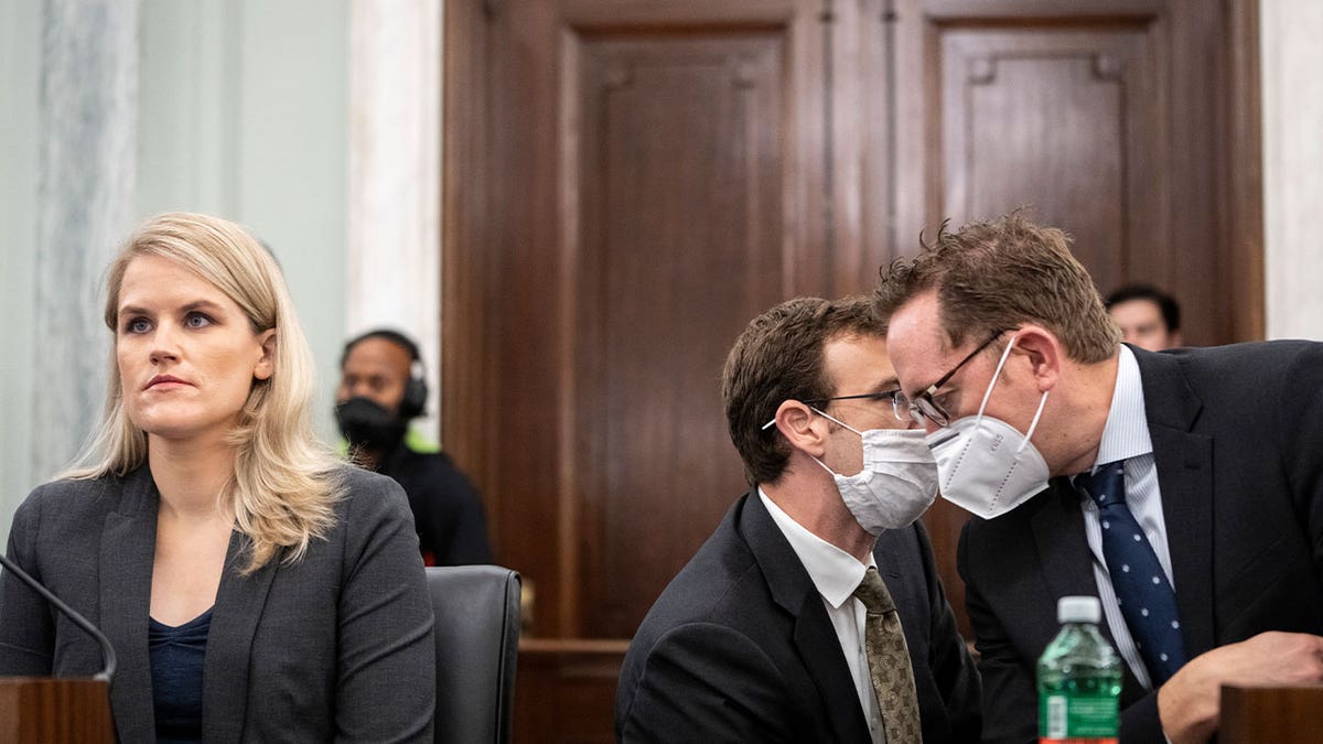 WASHINGTON, DC - OCTOBER 05: Aides confer as former Facebook employee Frances Haugen listens to opening statements during a Senate Committee on Commerce, Science, and Transportation hearing entitled 'Protecting Kids Online: Testimony from a Facebook Whistleblower' on Capitol Hill October 5, 2021 in Washington, DC. Haugen left Facebook in May and provided internal company documents about Facebook to journalists and others, alleging that Facebook consistently chooses profit over safety. (Photo by Drew Angerer/Getty Images)