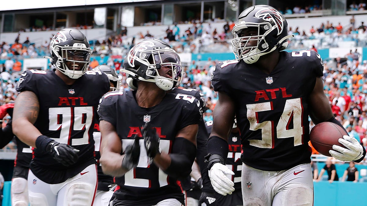 MIAMI GARDENS, FLORIDA - OCTOBER 24: Foye Oluokun #54 of the Atlanta Falcons celebrates with teammates after intercepting a pass from Tua Tagovailoa #1 of the Miami Dolphins (not pictured) during the fourth quarter at Hard Rock Stadium on October 24, 2021 in Miami Gardens, Florida. 
