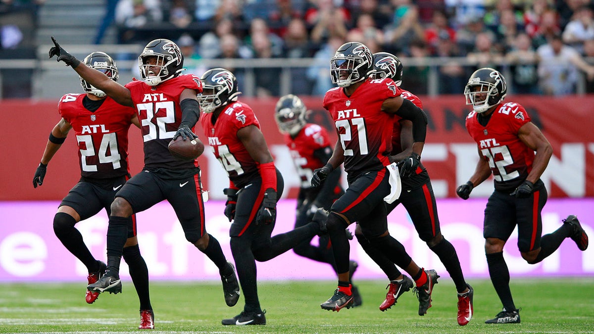 Atlanta Falcons safety Jaylinn Hawkins (32) celebrates making an interception during the first half of an NFL football game between the New York Jets and the Atlanta Falcons at the Tottenham Hotspur stadium in London, England, Sunday, Oct. 10, 2021.