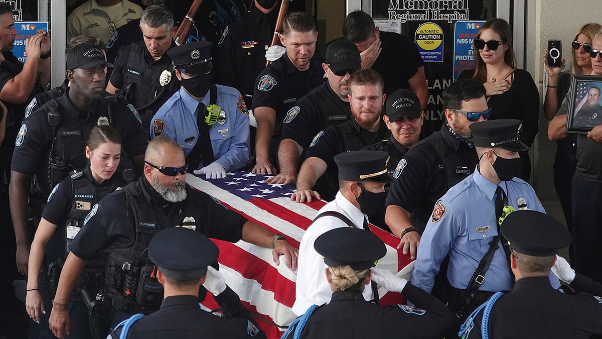 The dignified transfer of the remains of slain Hollywood Police Officer Yandy Chirino takes place at Memorial Regional Hospital in Hollywood, Florida, on Monday.