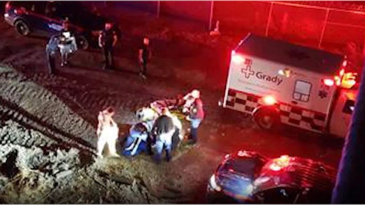 An Atlanta Police officer crashed a gate to get to a motorist whose vehicle fell down an embankment.